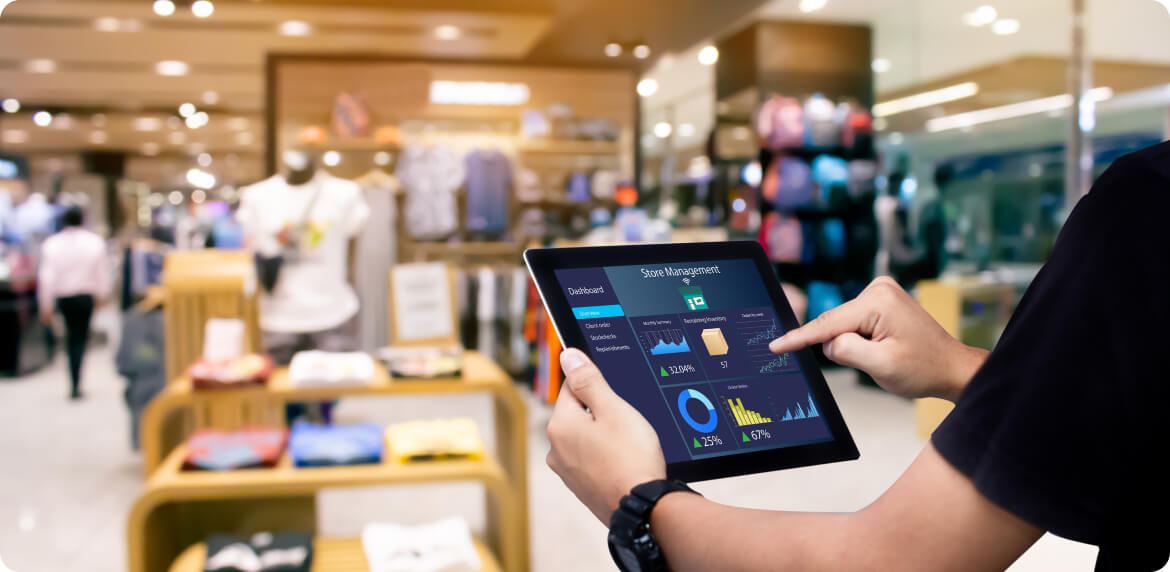 A person in a store examining a tablet, showcasing store management technology and retail interaction.